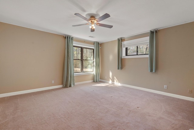 empty room featuring carpet floors, plenty of natural light, and baseboards