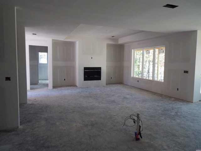 unfurnished living room with a fireplace and visible vents