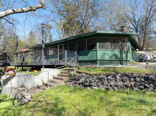 205 Ledgerock Rd, Hot Springs, AR 71913 - view of front of home featuring a chimney, a deck, stairs, and a sunroom
