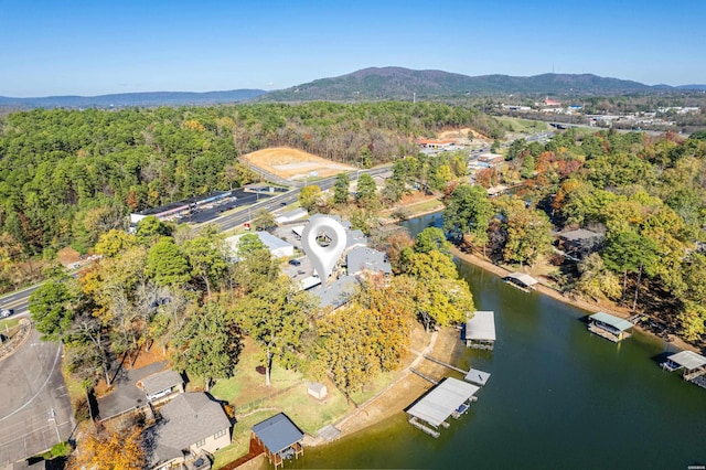 aerial view with a wooded view and a water and mountain view