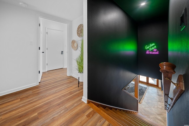 hall featuring wood finished floors and baseboards