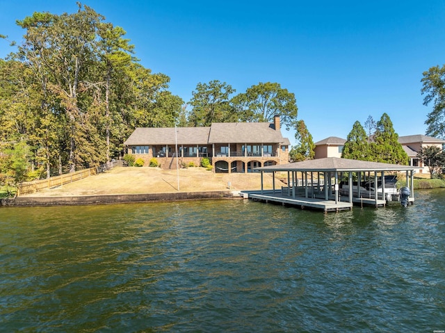 view of dock with a water view, boat lift, and fence