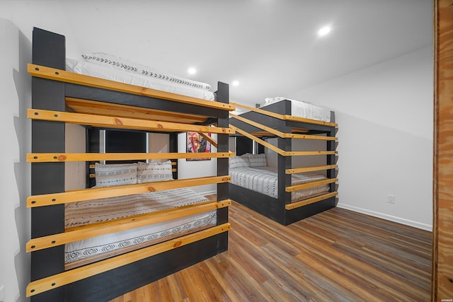 bedroom featuring dark wood-style flooring and baseboards