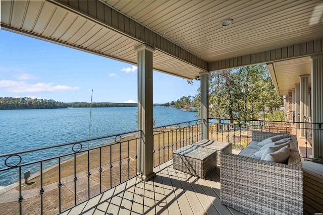 wooden deck with a water view and an outdoor hangout area