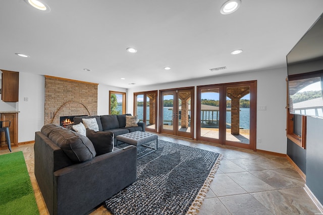 living room with a healthy amount of sunlight, a fireplace, visible vents, and recessed lighting