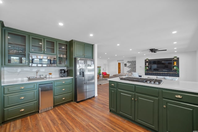 kitchen featuring appliances with stainless steel finishes, light countertops, and green cabinetry