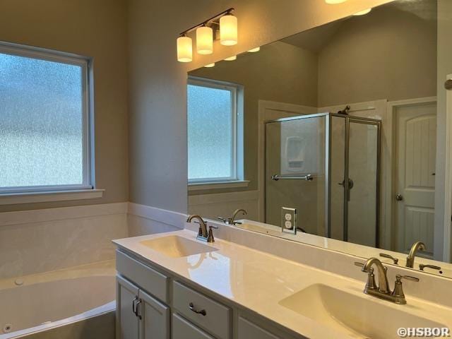 bathroom featuring plenty of natural light, a sink, and double vanity