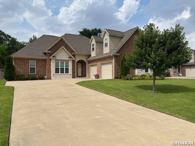 131 Coneflower Ct, Hot Springs, AR 71901 - traditional home with brick siding, driveway, a front lawn, and an attached garage