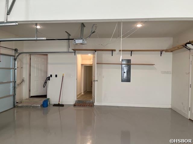 garage with electric panel, baseboards, and a garage door opener