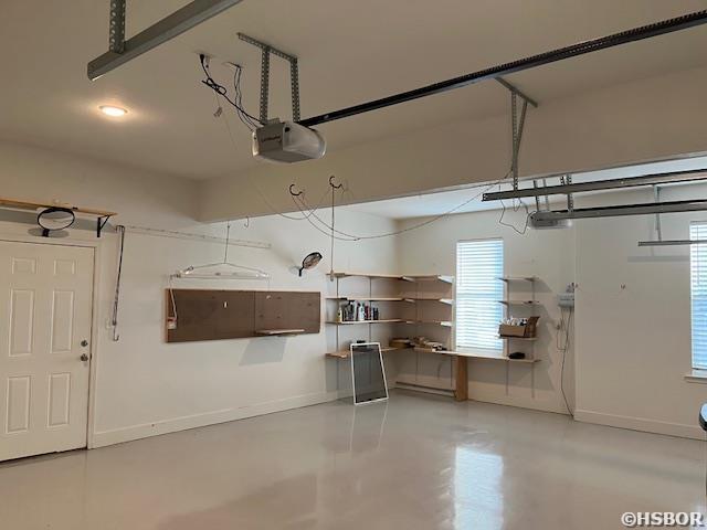 garage featuring baseboards and a garage door opener