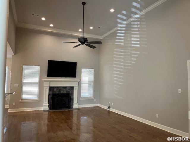 unfurnished living room featuring a fireplace with flush hearth, dark wood finished floors, and baseboards