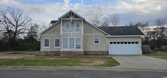 view of front of home featuring a shingled roof, concrete driveway, a balcony, and an attached garage