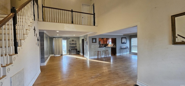 foyer with light wood finished floors, visible vents, and a wealth of natural light