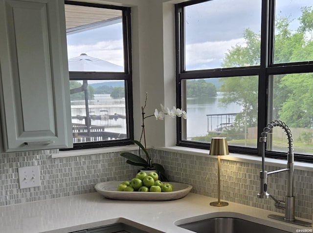 5371 Central Ave Unit 3C, Hot Springs, AR 71913 - kitchen view of a water view, a sink, backsplash, and light countertops
