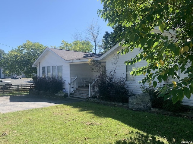 view of side of property featuring a yard and fence