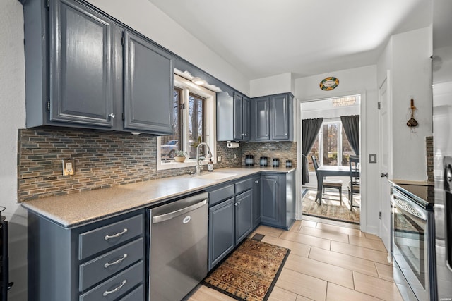 kitchen with stainless steel appliances, tasteful backsplash, plenty of natural light, and a sink