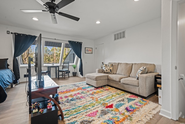 living area with baseboards, light wood finished floors, visible vents, and recessed lighting