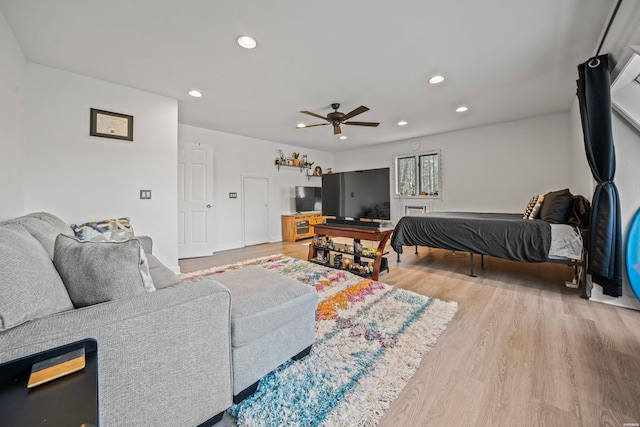 bedroom with recessed lighting, ceiling fan, and wood finished floors