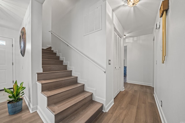 stairs featuring baseboards and wood finished floors