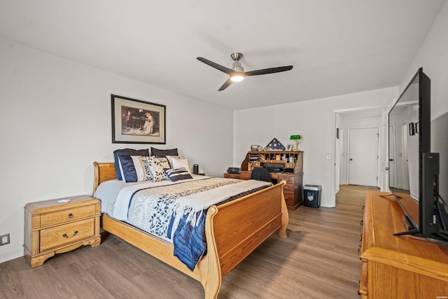 bedroom with dark wood-type flooring, baseboards, and a ceiling fan