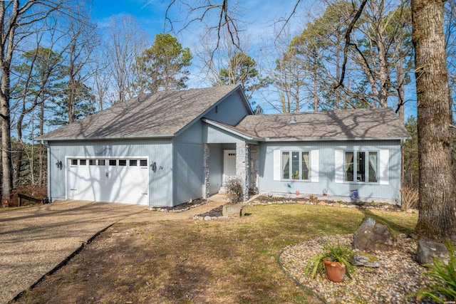 view of front facade featuring concrete driveway, a front lawn, and an attached garage