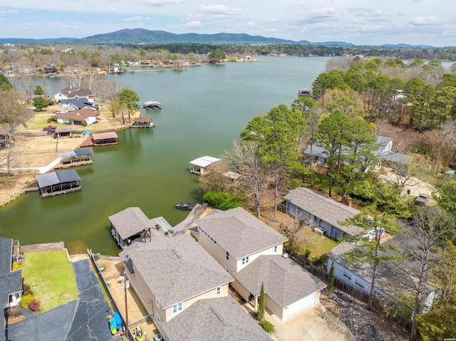 drone / aerial view featuring a residential view and a water and mountain view