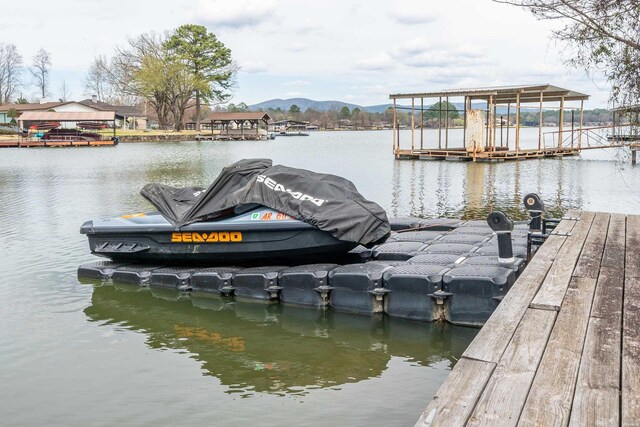 view of dock with a water and mountain view