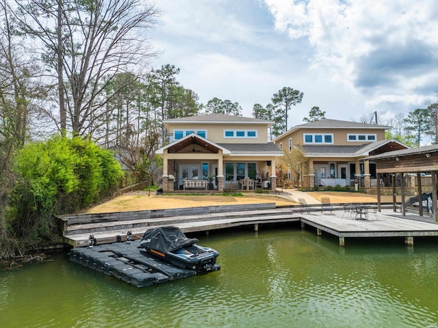 rear view of house featuring a water view