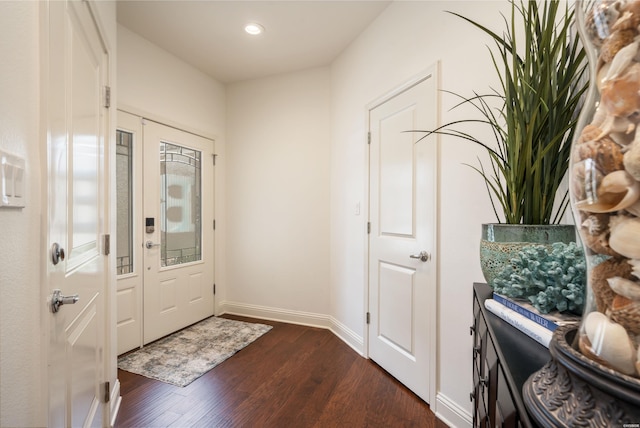 foyer featuring recessed lighting, dark wood finished floors, and baseboards