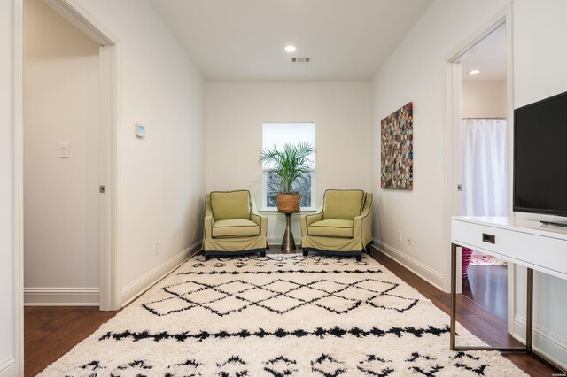 sitting room featuring dark wood-style floors, baseboards, and recessed lighting