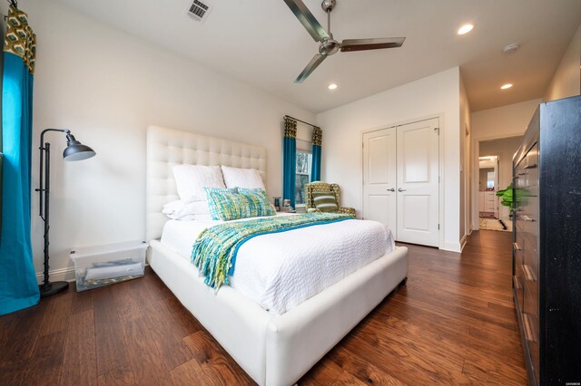 bedroom with recessed lighting, dark wood-style flooring, visible vents, baseboards, and a closet