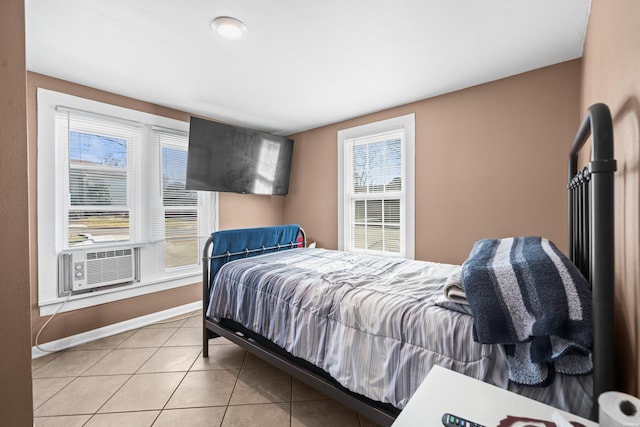 bedroom featuring light tile patterned floors, cooling unit, and baseboards