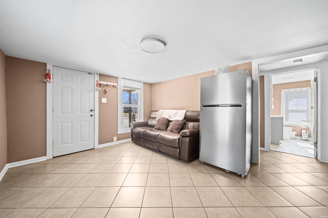 living room with light tile patterned flooring and baseboards