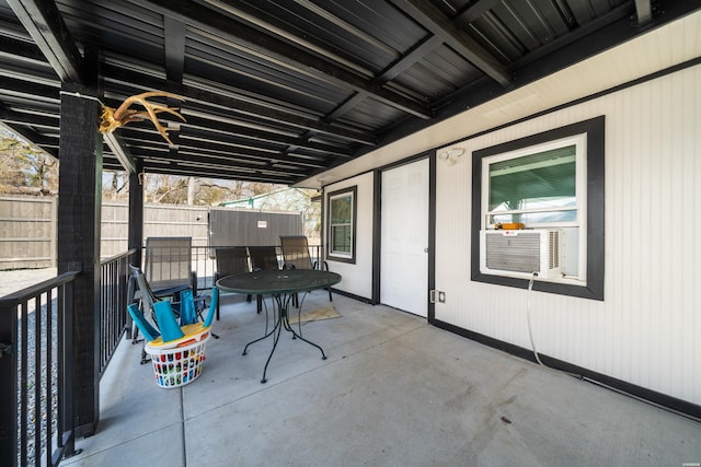 view of patio with outdoor dining area and fence