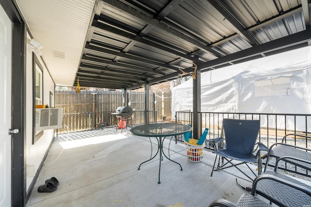 view of patio featuring outdoor dining space, grilling area, and fence