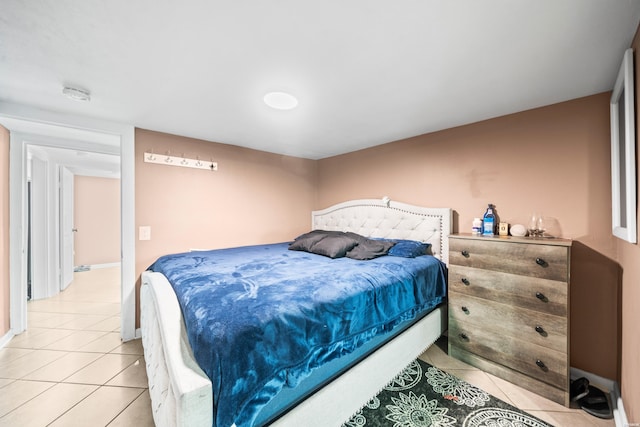 bedroom with light tile patterned flooring and baseboards