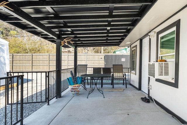 view of patio with a fenced backyard, cooling unit, and outdoor dining space