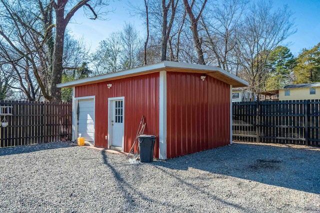 view of outdoor structure with an outbuilding and fence