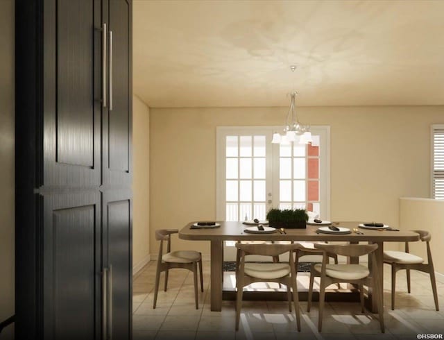 dining space with baseboards, french doors, and an inviting chandelier