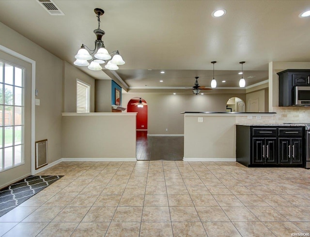 kitchen with visible vents, stainless steel microwave, open floor plan, and stove