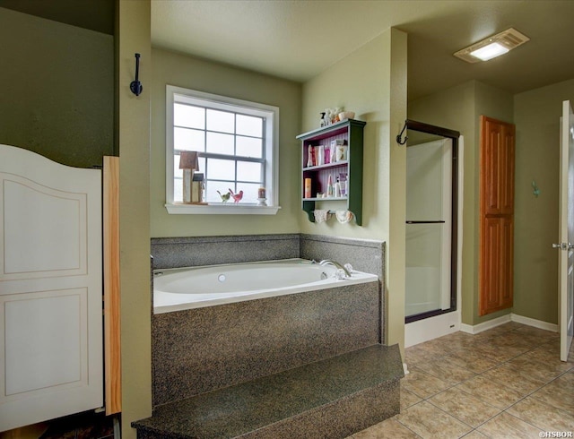 bathroom with a stall shower, tile patterned flooring, and a bath