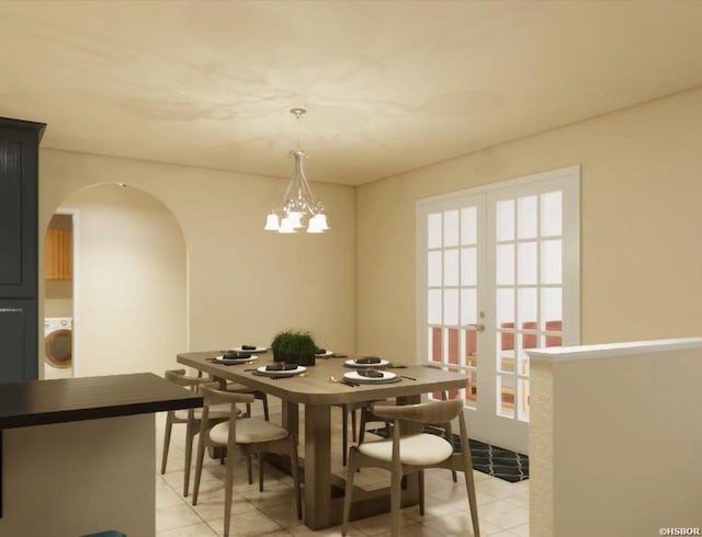 dining room featuring arched walkways, light tile patterned floors, french doors, washer / clothes dryer, and an inviting chandelier