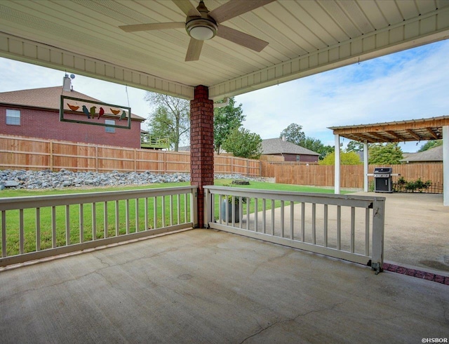 view of patio featuring ceiling fan, grilling area, and a fenced backyard