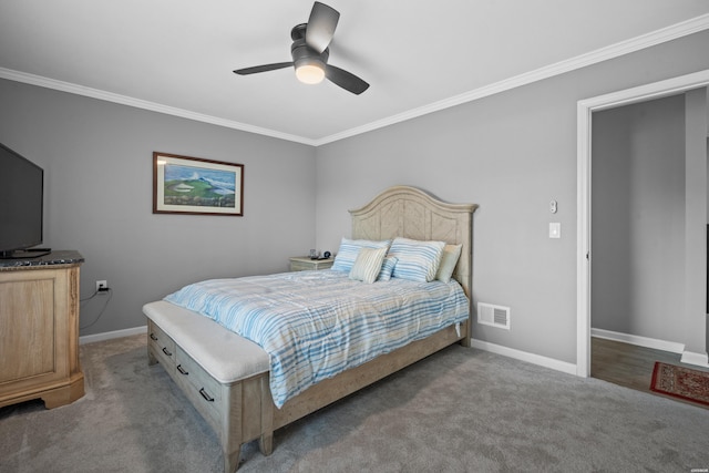 bedroom with carpet floors, visible vents, crown molding, and baseboards