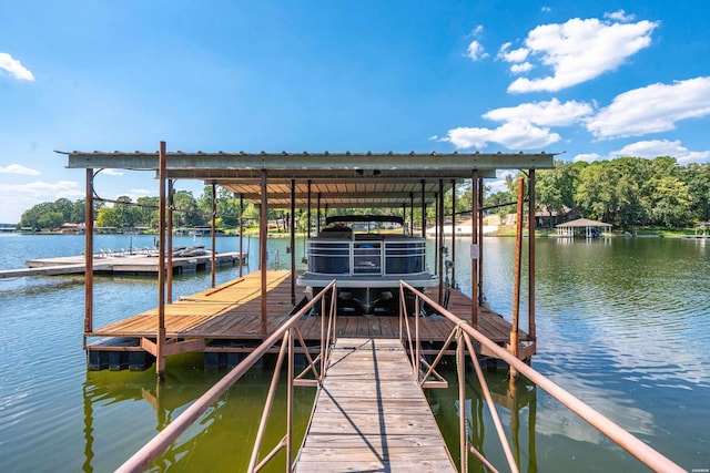 dock area with a water view and boat lift