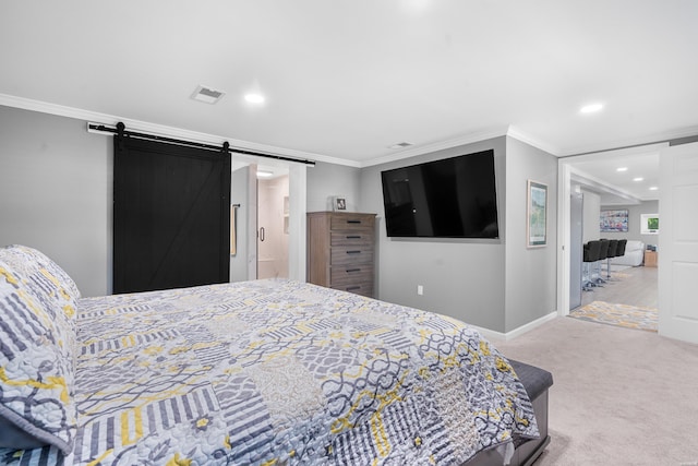 bedroom with carpet floors, visible vents, a barn door, ornamental molding, and baseboards