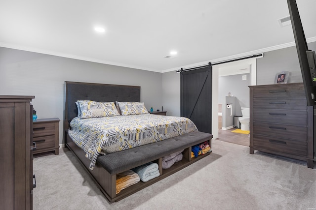 bedroom featuring ornamental molding, light colored carpet, visible vents, and a barn door