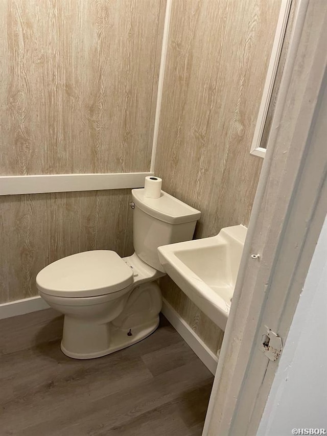 611 Lakeland Unit 30, Hot Springs, AR 71913 - bathroom with toilet, wood finished floors, wood walls, and baseboards