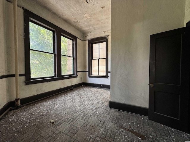 spare room featuring baseboards