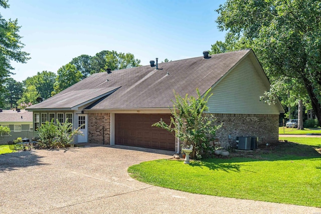 ranch-style house featuring a garage, driveway, brick siding, and a front yard